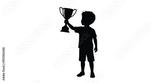 Young boy proudly holds a trophy in a striking silhouette