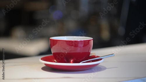A cup of coffee in a cozy cafe with steam appearing