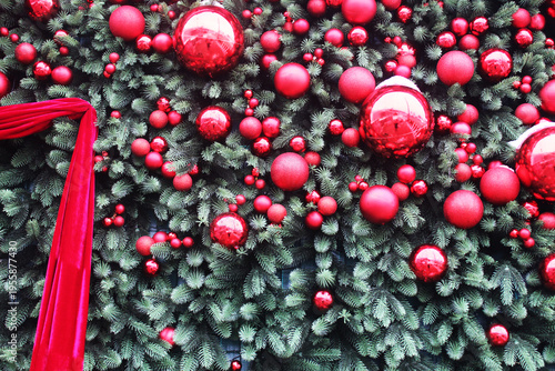 Christmas New Year background. Red Christmas balls against the background of green spruce branches