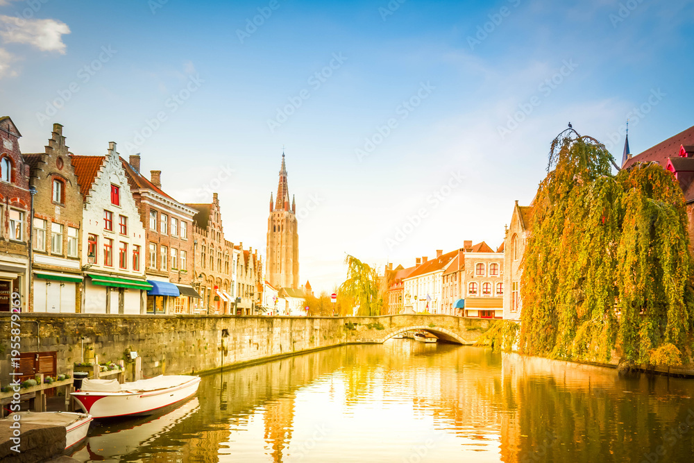 Fototapeta premium scene of old town with canal and tower of Vrouwekerk , Belgium
