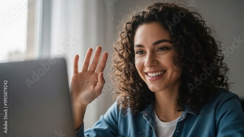 Woman waving hello on video call