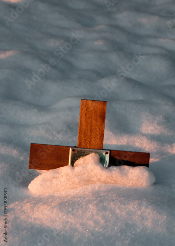 A wooden cross in the snow