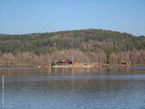 Photos Calm waters with distant hillside house