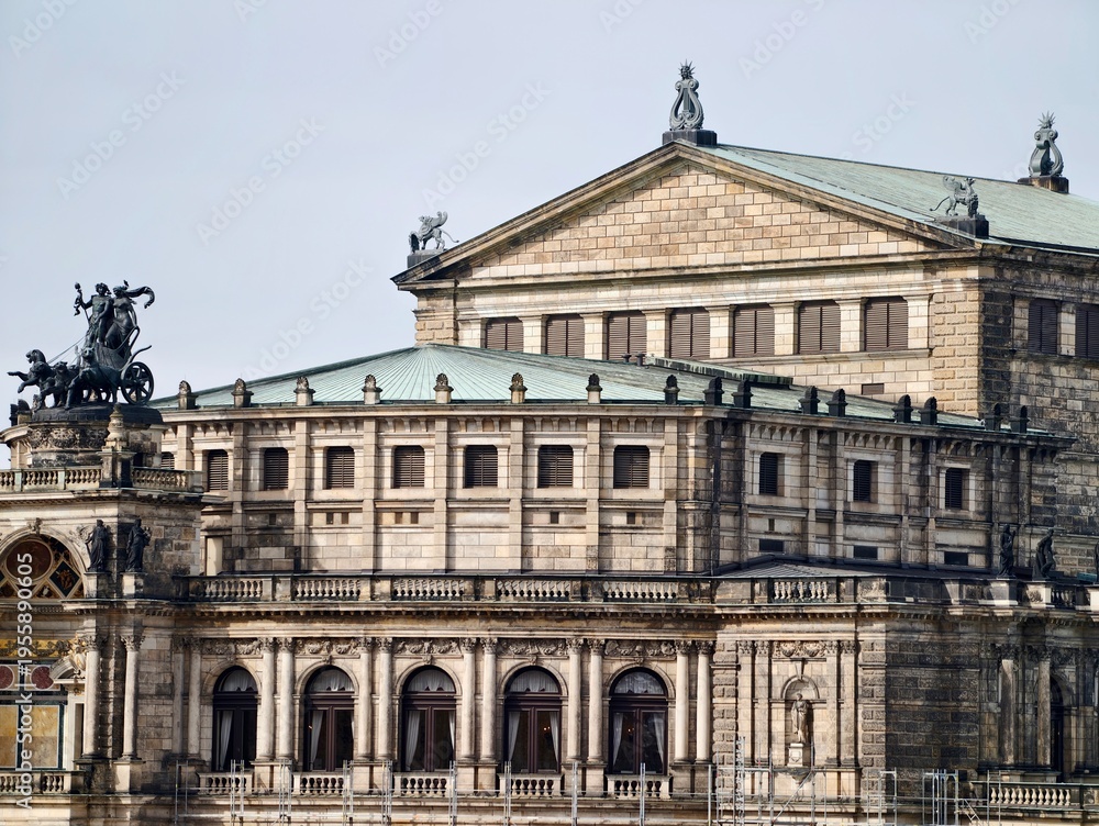 Fototapeta premium Elegant historic facade. Stylish neoclassical building showcasing sculptures and decorative elements