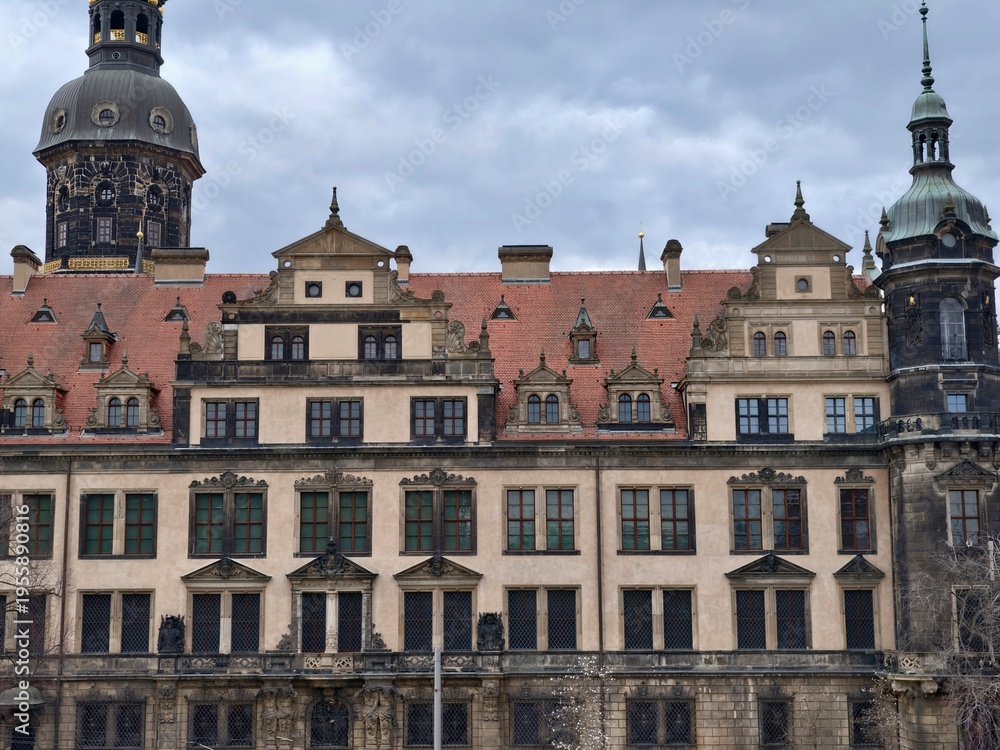 Obraz premium Ornate baroque facade with towers and spires, detailed ornament, weathered stone and historic charm