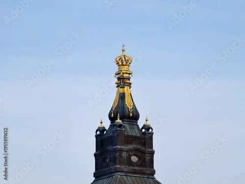 Photographer captures reflective gilded ornament on turret for historical archive purposes