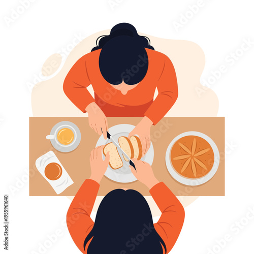Two women preparing and slicing bread for a morning meal at a table