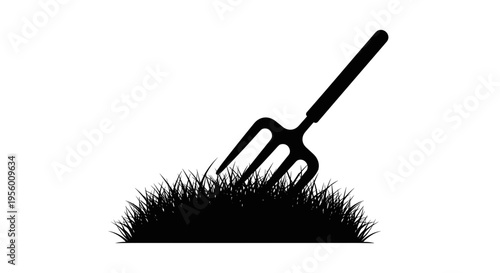 Black silhouette of a garden pitchfork plunged into a clump of grass representing agriculture and outdoor work isolated