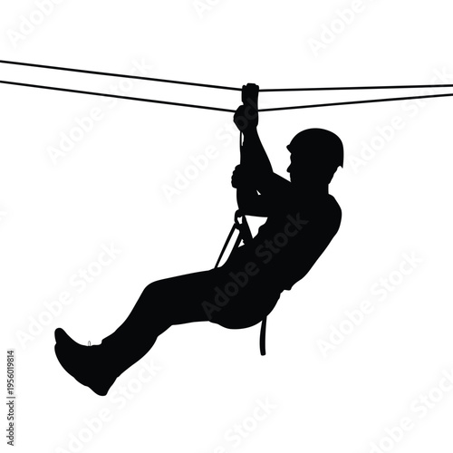 Silhouette of a person ziplining across a cable adventure activity