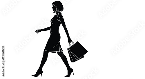 Silhouette of a woman walking with shopping bags