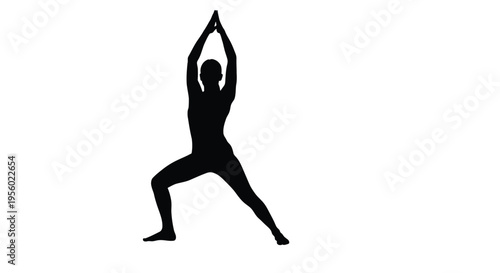 Silhouette of a woman practicing yoga in a warrior pose