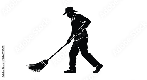 Silhouette of a man sweeping with a broom