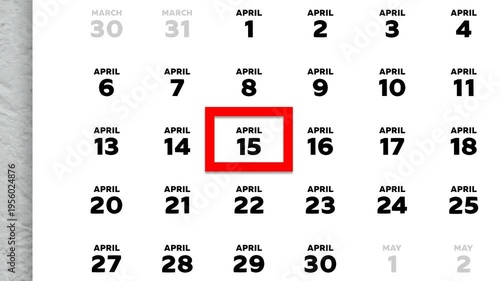 The date April 15th marked with a red cursor on the wall calendar 2026