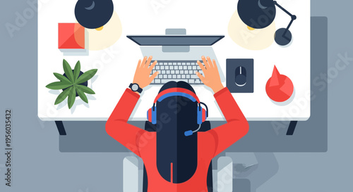 overhead view of woman working on laptop at desk with office supplies