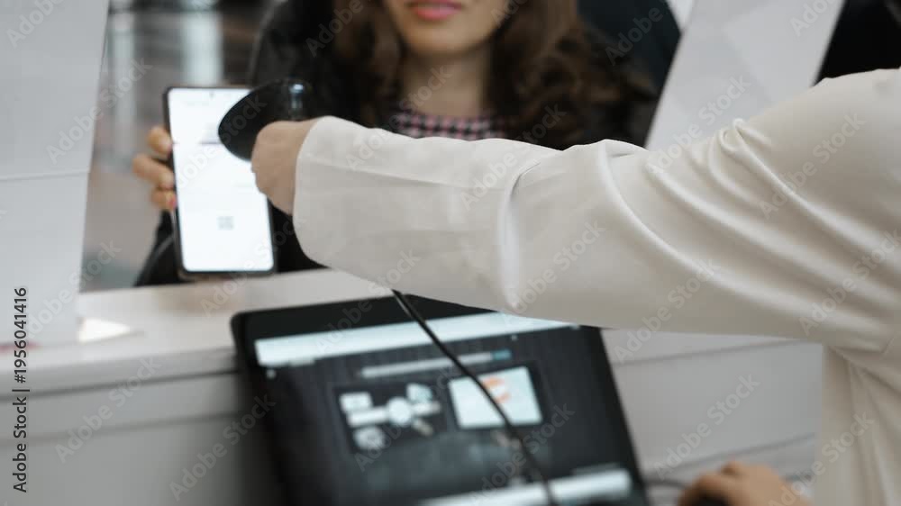 Close up of attendee QR code scanning at conference registration desk ...