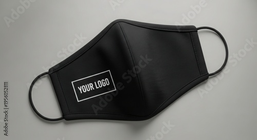 Black face mask with a white logo placeholder on gray background