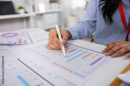 Fotografi Focused business person analyzing financial graph and chart on document in offic
