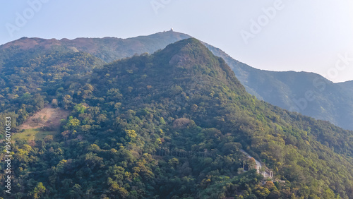 Photography Kwun Yam Shan forested peak rising beneath clear sky March 7 2026