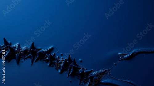 Sleek black fluid with sharp protrusions and tiny bubbles flows dynamically against a deep blue backdrop, creating an ab