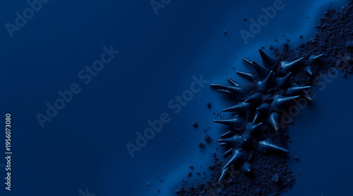 Abstract composition with spiked irregular shapes scattered among fine particles against a deep blue backdrop, conveying