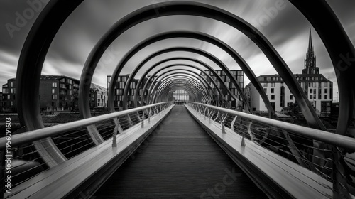 Black and white photo of a spiraling pedestrian bridge with strong leading lines