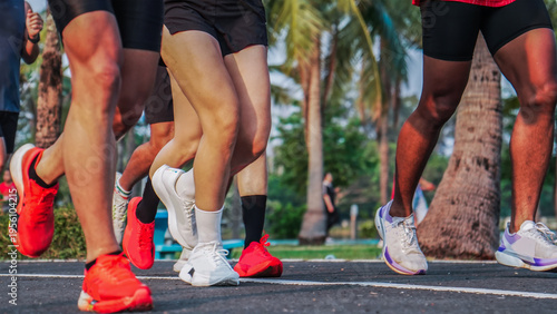 Group running session in park environment showing active people training together for health endurance and outdoor fitness lifestyle