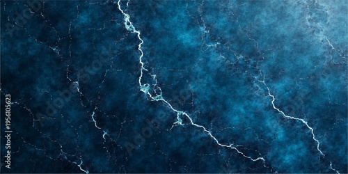A powerful lightning bolt strikes across a dark blue grunge wall background during a heavy night thunderstorm as electric energy flashes through the stormy sky