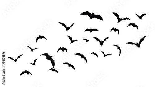 A flock of bats flying in the sky at dusk