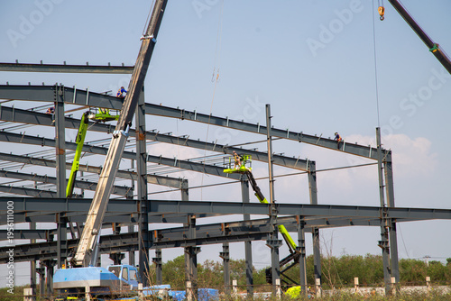 Tableau sur toile Large Steel-Frame Warehouse Structure Under Construction with Crane and Worker,C