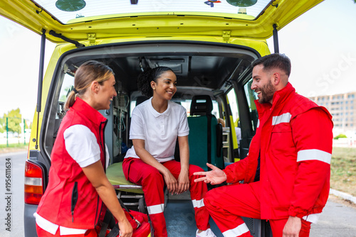 Canvastavla Group of paramedics talking at the back of an ambulance