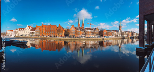 Panoramic Lubeck Old Town waterfront reflected in Trave River