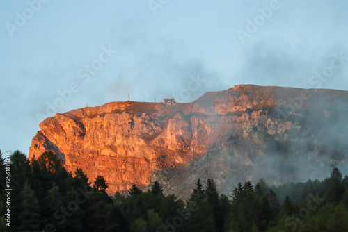 Sunset glow across towering mountain ridge