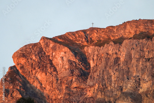 Golden sun over rugged alpine cliffs