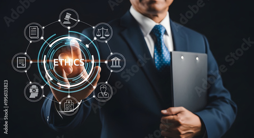 Businessman holding tablet with futuristic ethics icons floating nearby