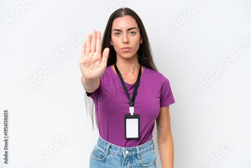 Young caucasian woman with ID card isolated on white background making stop gesture