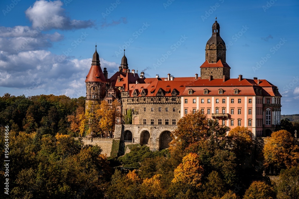 Fototapeta premium Ksiaz Castle in autumn, colorful fall forest and historic architecture in Lower Silesia, Poland.