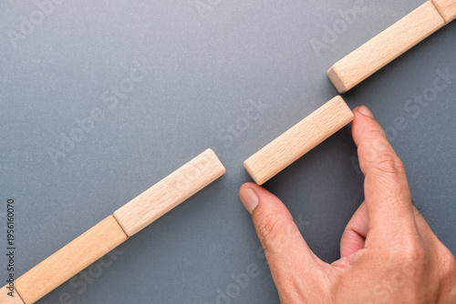 Tableau sur toile Hand placing wooden block to bridge a gap, symbolizing problem solving, connecti