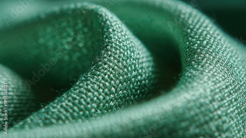 Closeup green woven fabric texture background with visible weave and folds for textile design and surface detail backdrop