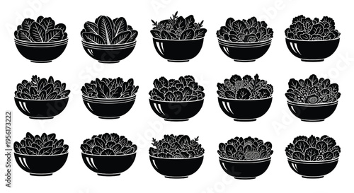 A set of black bowls filled with various leafy greens