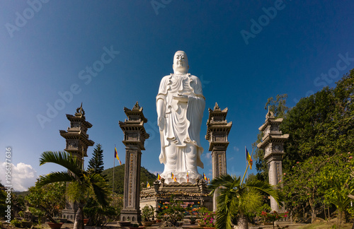 Standing Buddha statue against sky at Tong Lam Son Temple Nha Trang Vietnam