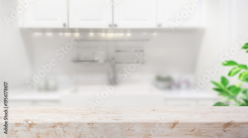 Selective focus.White vintage rustic wood table island  with cozy white wall kitchen background for design product