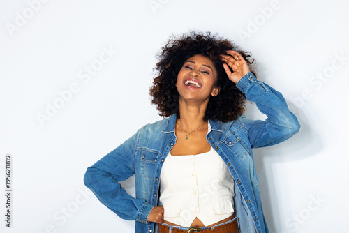 young woman with afro hair isolated on background laughing out loud