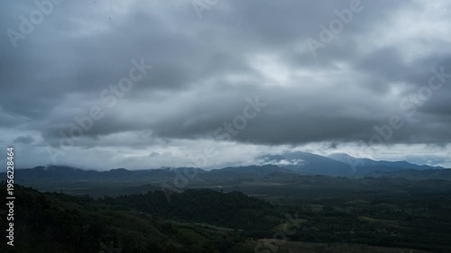 An awe-inspiring, majestic vista of mountains shrouded in the drama of an overcast sky. A serene landscape. 
