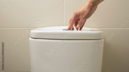 Hand pushing a button to flush a close tool at home