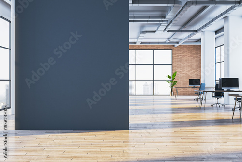 Modern office interior with large blank dark wall and open workspace with windows, desks, and contemporary design elements for mockup use. 3D Rendering