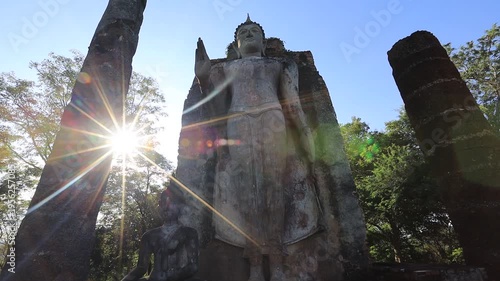 The video's natural background depicts the atmosphere of the ancient Sukhothai Historical Park, an educational site featuring ancient Buddha statues and pagodas.
