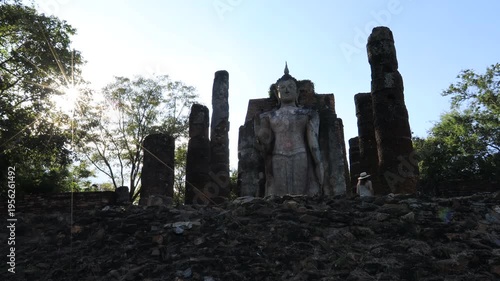 The video's natural background depicts the atmosphere of the ancient Sukhothai Historical Park, an educational site featuring ancient Buddha statues and pagodas.