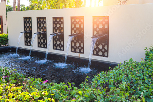 A composition of mini waterfalls at the entrance to the hotel.