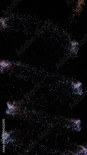 Abstract light trails spiraling against dark background for festive display