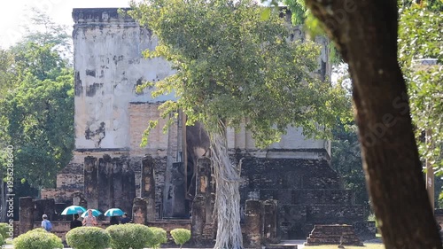 The video's natural background depicts the atmosphere of the ancient Sukhothai Historical Park, an educational site featuring ancient Buddha statues and pagodas.